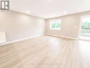 South Stormont townhouse for rent - A spacious room with wooden flooring and a large window.