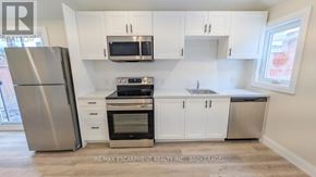 St. Catharines (Grapeview) apartment for rent - A kitchen with white cabinets and stainless steel appliances.
