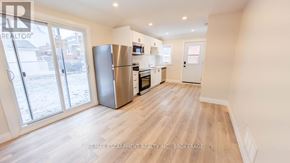 St. Catharines (Grapeview) apartment for rent - A kitchen with a refrigerator, microwave, and oven.