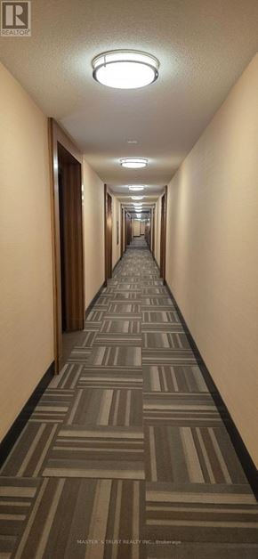 Markham (Unionville) condo for rent - A long hallway with a striped carpet and ceiling lights.