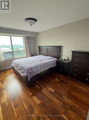 Markham (Unionville) condo for rent - A bedroom with a bed, dresser, and window.