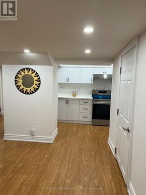 Vaughan (Patterson) apartment for rent - A kitchen with white cabinets and a wooden floor.