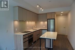 Vaughan (Beverley Glen) condo for rent - A kitchen with a white countertop and wooden cabinets.