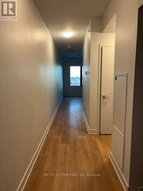 Vaughan (Concord) condo for rent - A long hallway with wood floors and white walls.