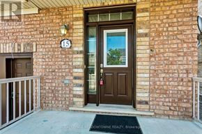 Caledon apartment for rent - The front door of a building with a glass window and a brown door.
