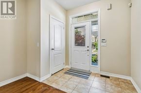 Caledon apartment for rent - A white door with a glass window is in a room with a tiled floor.
