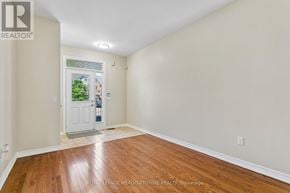 Caledon apartment for rent - A room with wooden floors and white walls, with a door leading outside.