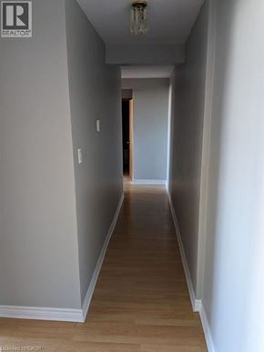 Cambridge apartment for rent - A long hallway with wood floors and white walls.