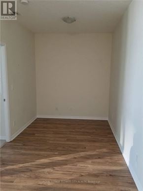 Toronto (Waterfront Communities) condo for rent - A room with wooden flooring and white walls.
