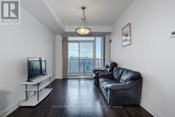 Markham (Thornhill) condo for rent - A living room with a black leather couch and a television.