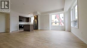 Newmarket (Glenway Estates) townhouse for rent - A spacious living room with a kitchen area in the background.