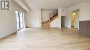 Newmarket (Glenway Estates) townhouse for rent - A spacious living room with a staircase leading to the upper floor.