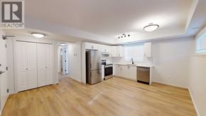 Grande Prairie apartment for rent - A spacious kitchen with wooden floors and white walls.
