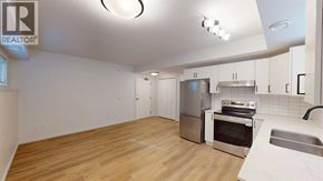 Grande Prairie apartment for rent - A kitchen with wooden floors and stainless steel appliances.