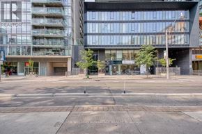 Toronto (Church-Yonge Corridor) condo for rent - A street view of a city intersection with buildings and a street sign.