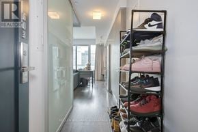 Toronto (Church-Yonge Corridor) condo for rent - Shoes are displayed on a shoe rack in a hallway.