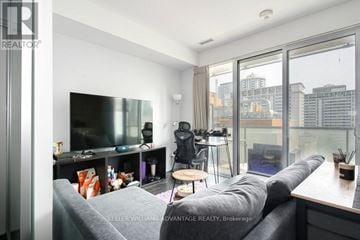 Toronto (Church-Yonge Corridor) condo for rent - A living room with a grey couch and a television.