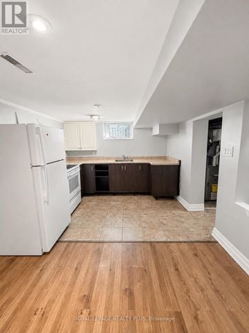 Mississauga (Mineola) apartment for rent - A kitchen with white appliances and wood floors.
