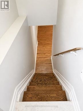 Mississauga (Mineola) apartment for rent - A wooden staircase with white walls and a wooden handrail.