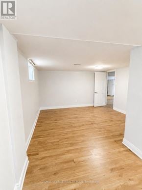 Mississauga (Mineola) apartment for rent - A room with wooden floors and white walls.
