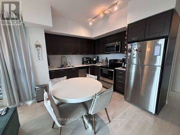 Toronto (Mimico) condo for rent - A kitchen with a table and chairs.