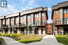 Paris townhouse for rent - A row of modern townhouses with balconies and a walkway in front.