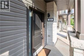 Paris townhouse for rent - A modern house entrance with a glass door and a number 44 on the wall.