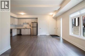 Paris townhouse for rent - A spacious kitchen with white cabinets and a refrigerator.