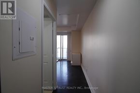 Toronto (Bay Street Corridor) condo for rent - A hallway with a door on the left and a window on the right.