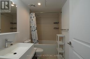 Toronto (Bay Street Corridor) condo for rent - A bathroom with a sink, toilet, and bathtub.