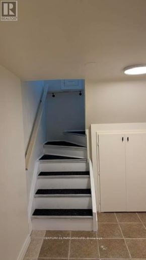 Toronto (Cliffcrest) apartment for rent - A staircase with a white railing and black steps leads to a blue door.