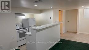 Toronto (Cliffcrest) apartment for rent - A kitchen with a stove top oven and a refrigerator.