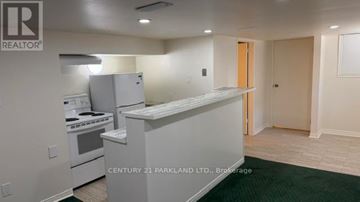 Toronto (Cliffcrest) apartment for rent - A kitchen with a stove top oven and a refrigerator.