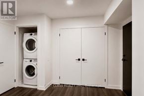 Toronto (North St. James Town) condo for rent - A laundry room with a washer and dryer in it.