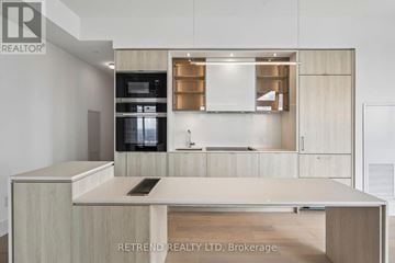 Toronto (Annex) condo for rent - A modern kitchen with wooden cabinets and a central island.