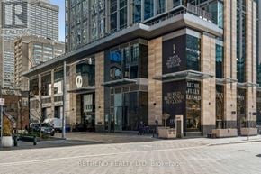 Toronto (Annex) condo for rent - A building with a sign that says "Retail Fully Leased" on the front.
