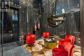 Toronto (Annex) condo for rent - A modern living room with a glass wall and a chandelier.