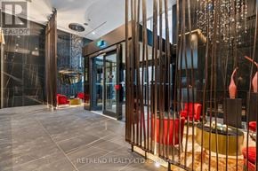 Toronto (Annex) condo for rent - A modern interior space with a glass wall and a metal railing.