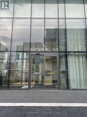 Vaughan (Vaughan Corporate Centre) condo for rent - The entrance to a building with a glass door and a sign that reads "Buttermill Ave.".