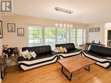 Mississauga (Port Credit) apartment for rent - A living room with a black and white sofa and a wooden coffee table.