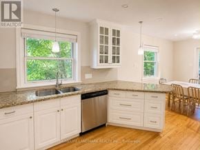 Mississauga (Port Credit) apartment for rent - A kitchen with white cabinets and a granite countertop.
