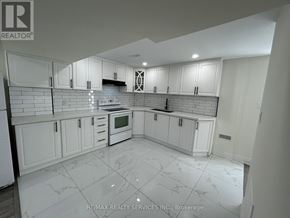 Brampton (Westgate) apartment for rent - A kitchen with white cabinets and a tiled floor.