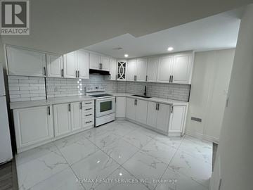 Brampton (Westgate) apartment for rent - A kitchen with white cabinets and a tiled floor.