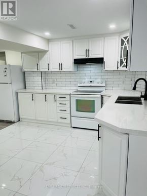 Brampton (Westgate) apartment for rent - A white kitchen with a tile floor and white cabinets.