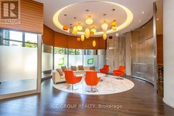Toronto (Agincourt South-Malvern West) condo for rent - A modern living room with orange chairs and a wooden floor.