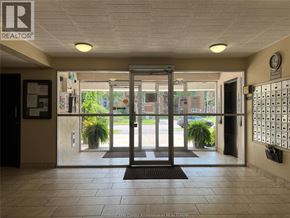Windsor condo for rent - The image shows the entrance to a building with a glass door and a sign that reads "REALTOR".