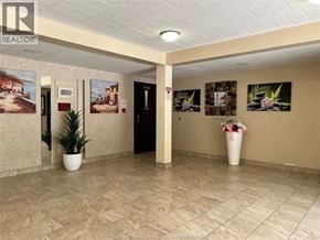 Windsor condo for rent - A hallway with a REALTOR sign on the wall.