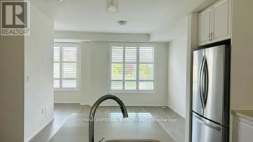 Richmond Hill (Westbrook) townhouse for rent - A kitchen with a stainless steel refrigerator and a sink.
