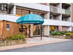 North Vancouver apartment for rent - The entrance to a building with a blue awning that says "The Millhouse".