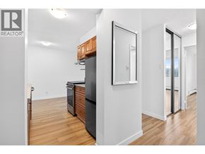 North Vancouver apartment for rent - A kitchen with a black fridge and wooden cabinets.